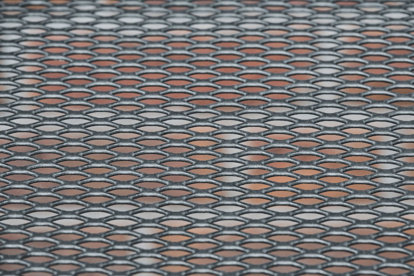 Close-up of perforated metal grid pattern showing the material used in micro-mesh gutter guards