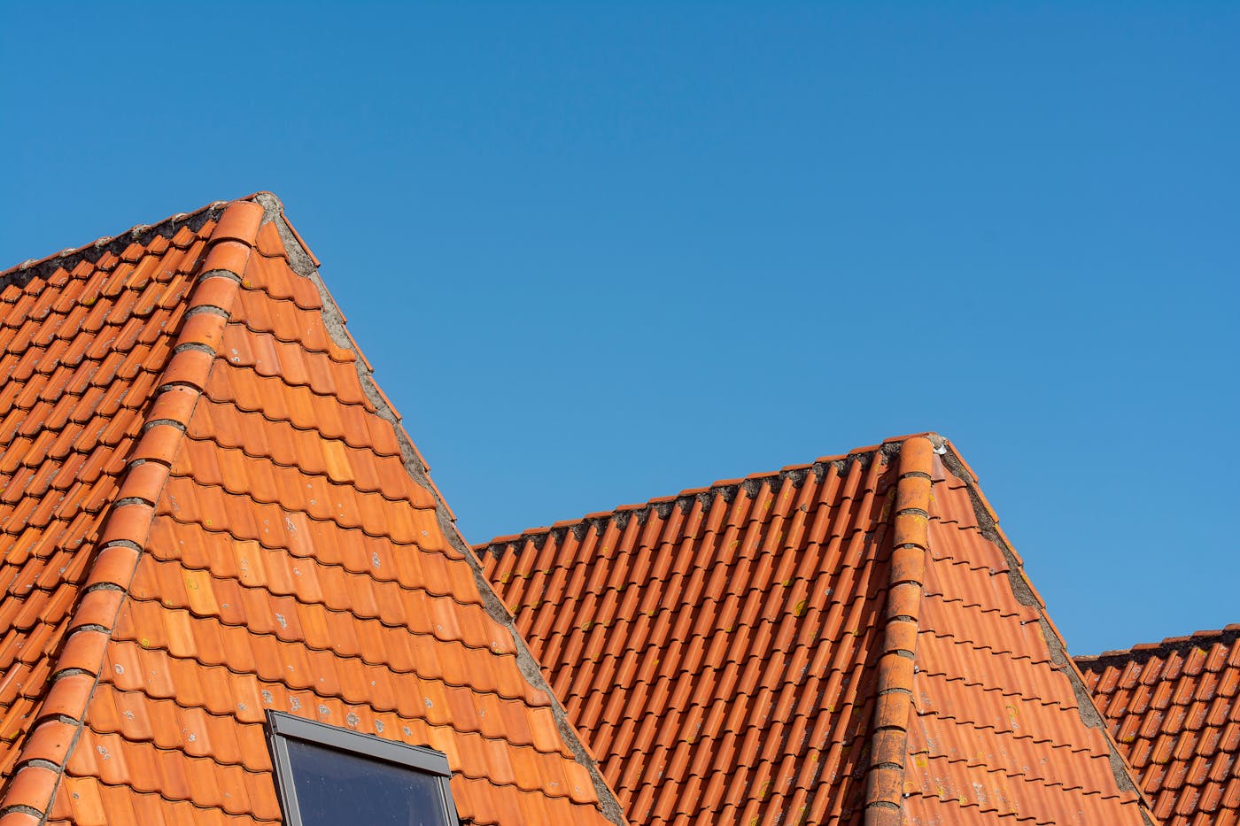 Red tiled roof showing gutter line along eave where guards would be installed
